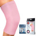 Pink Dr. Arthritis knee compression sleeve on a human leg with packaging and handbook displayed to the right.