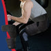 A person wearing a Stabilizing Hip Support Brace by Dr. Arthritis performing squats with a focus on the product.