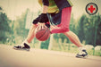 A player dribbling a basketball on the court with Dr. Arthritis Copper Infused Wrist Sleeve [Single] support.