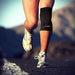 A man running on a road with a Dr. Arthritis Copper Infused Knee Sleeve for arthritis support.