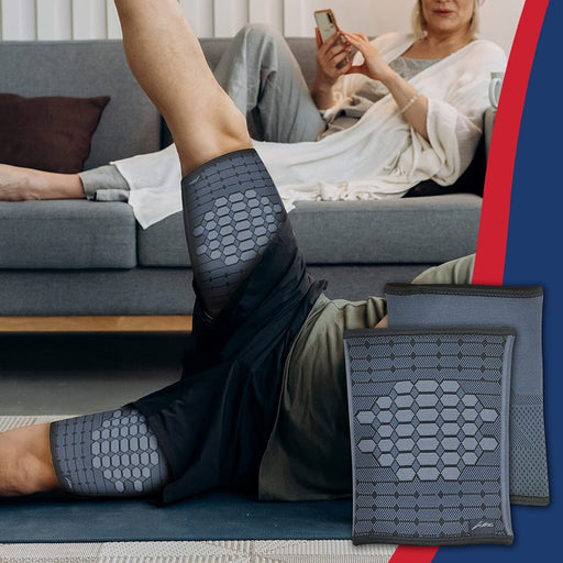 A person lying on the floor with Dr. Arthritis Thigh Compression Sleeve for Women and Men, using a smartphone while a woman sits on the couch in the background.